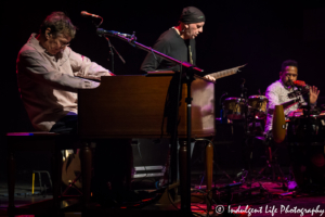 Steve Winwood performing live with band members José Neto and Edwin Sanz at Uptown Theater in Kansas City, MO on March 2, 2018.