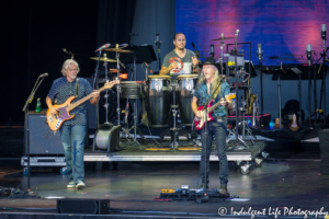 Guitarist Patrick Simmons with bass player John Cowan and percussionist Marc Quiñones of The Doobie Brothers live at Starlight Theatre in Kansas City, MO on June 18, 2018.