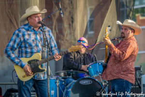 Ricochet frontman Heath Wright with drummer Chris Hempfling and bass guitarist Shane Mullins at Festival on the Trails in Gardner, KS on June 9, 2018.