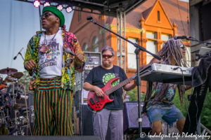 Lead singer Ras Neville in concert with keyboardist Edward Turner and bass guitar player Kenny Jahn at Live on Mass in Lawrence, KS on June 29, 2018.