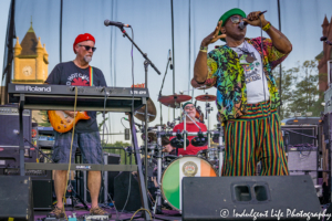 Ras Neville performing live with keyboardist Scotty Wenzel and drummer Joe Cameron at the Live on Mass event in downtown Lawrence, KS on June 29, 2018.