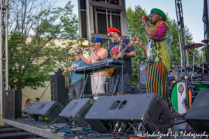 Ras Neville with keyboard player and guitarist Scotty Wenzel, trombone player Zach Dinges and saxophone player Alex Toepfer at Live on Mass in Lawrence, KS on June 29, 2018.