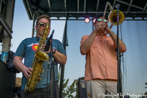 Saxophone player Alex Toepfer and trombone player Zach Dinges for Ras Neville & The Kingstonians performing Live on Mass in downtown Lawrence, KS on June 29, 2018.