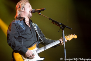 Country music's Travis Tritt performing live on the guitar at Silverstein Eye Centers Arena in Independence, MO on May 25, 2019.