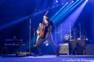 Country music's Travis Tritt playing the acoustic guitar during "I'm Gonna Be Somebody" on his concert tour stop at Silverstein Eye Centers Arena in Independence, MO on May 25, 2019.