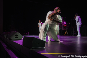 Boyz II Men tenor vocalist Wanya Morris kneeling while singing "On Bended Knee" at Kauffman Center's Muriel Kauffman Theatre in Kansas City, MO on October 2, 2019.