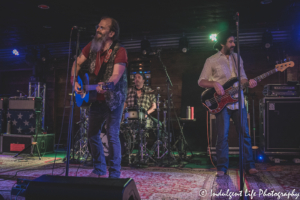 Steve Earle performing with bass guitarist Jeff Hill and drummer Brad Pemberton at Knuckleheads Saloon in Kansas City, MO on July 9, 2021