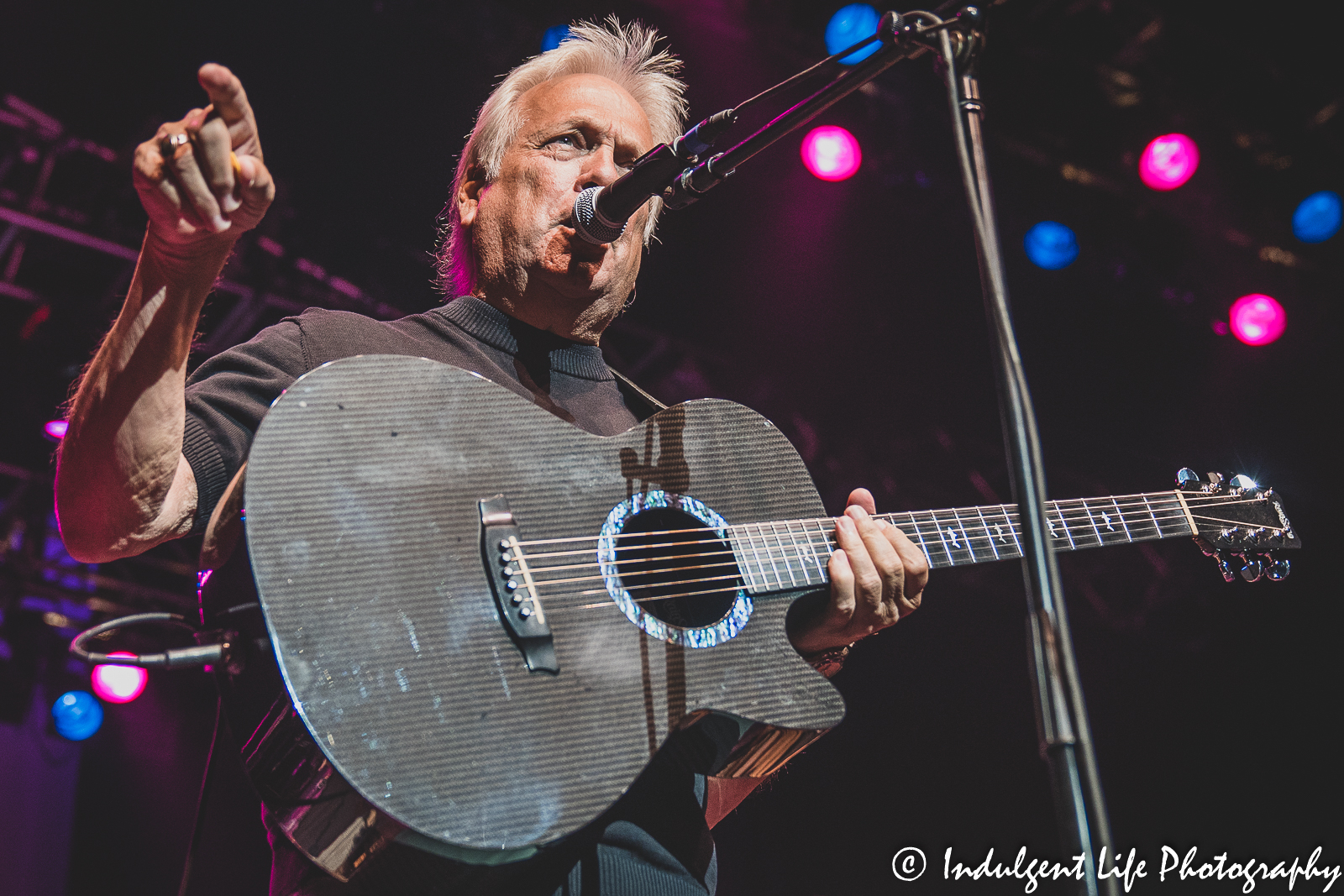 The Ozark Mountain Daredevils lead vocalist John Dill singing and playing the guitar at Ameristar Casino Hotel Kansas City on August 21, 2021.