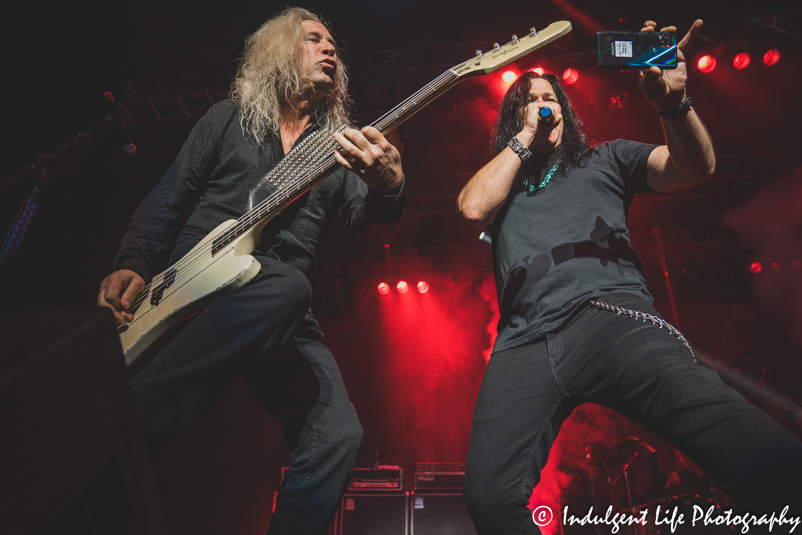 Frontman Mark Slaughter filming the Star Pavilion crowd with bass guitar player Dana Strum at Ameristar Casino in Kansas City, MO on October 1, 2021.