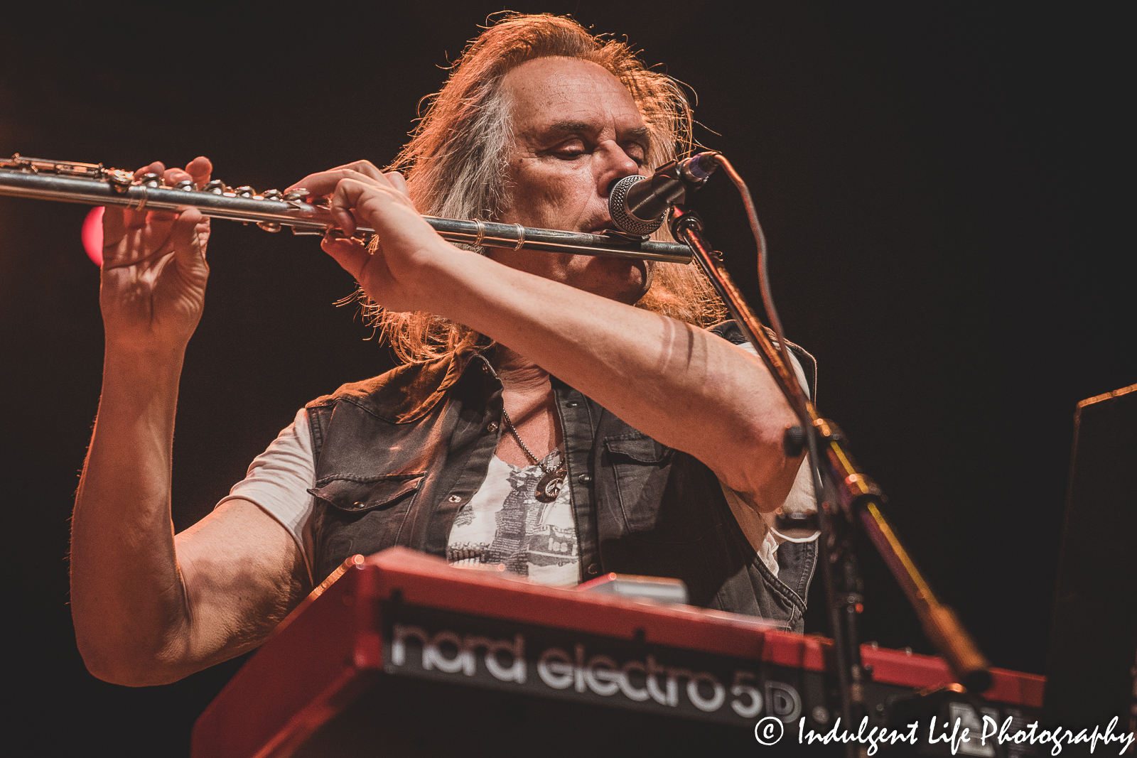 The Guess Who multi-instrumentalist Leonard Shaw playing the flute live at Ameristar Casino Hotel Kansas City on November 20, 2021.