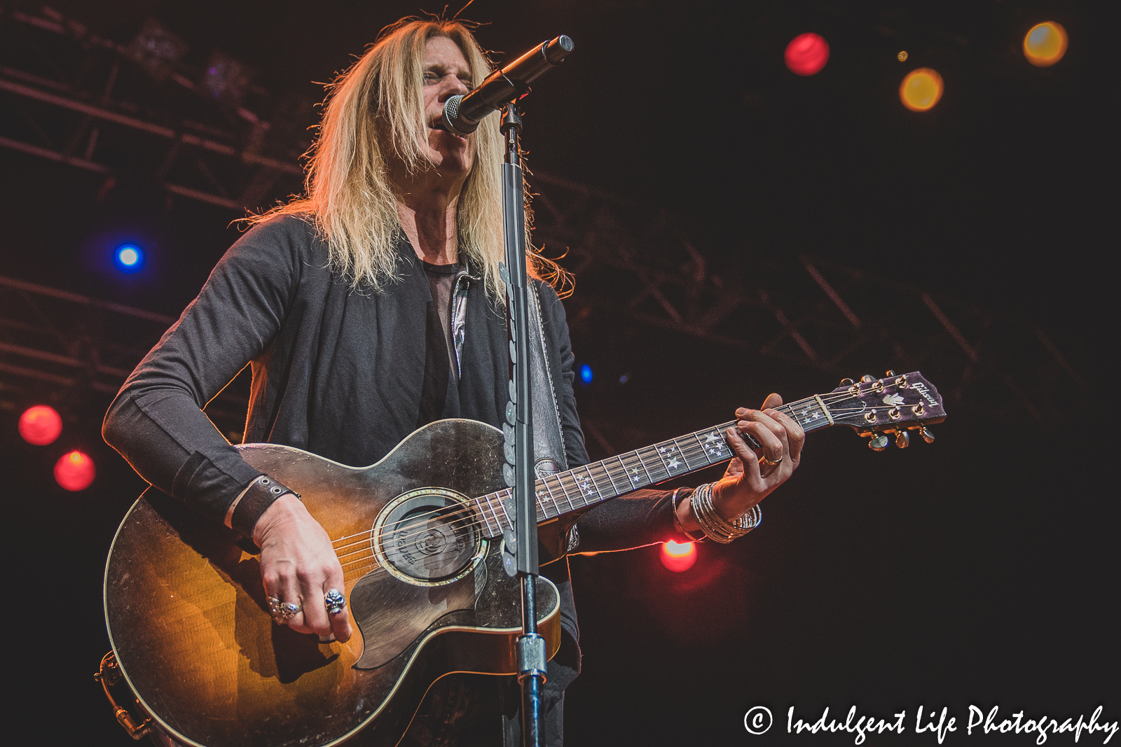 The Guess Who lead singer Derek Sharp singing and playing the acoustic guitar live at Ameristar Casino Hotel Kansas City on November 20, 2021.