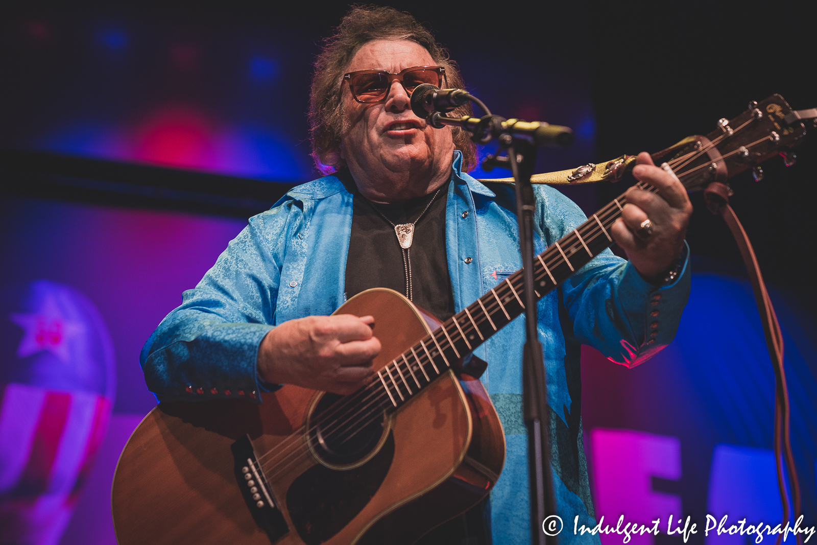 Don McLean singing and playing the acoustic guitar at Uptown Theater in Kansas City, MO on April 29, 2022.