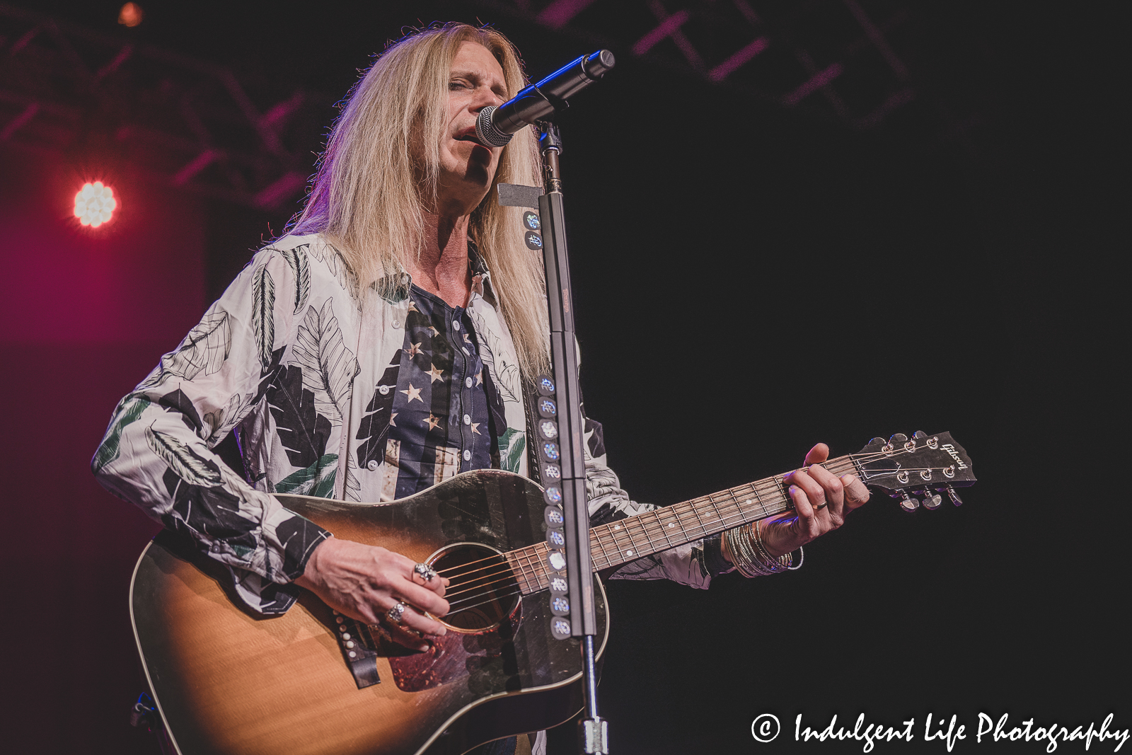 Lead singer Derek Sharp of The Guess Who playing the acoustic guitar at Ameristar Casino Hotel Kansas City, MO on September 9, 2022.