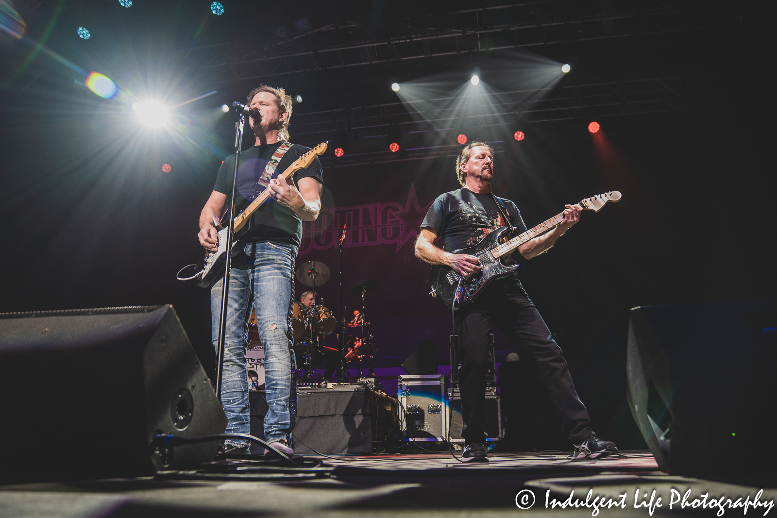 Frontman Todd Pettygrove of Shooting Star performing with guitarist Chet Galloway and drummer Steve Thomas at Ameristar Casino in Kansas City, MO on March 18, 2023.